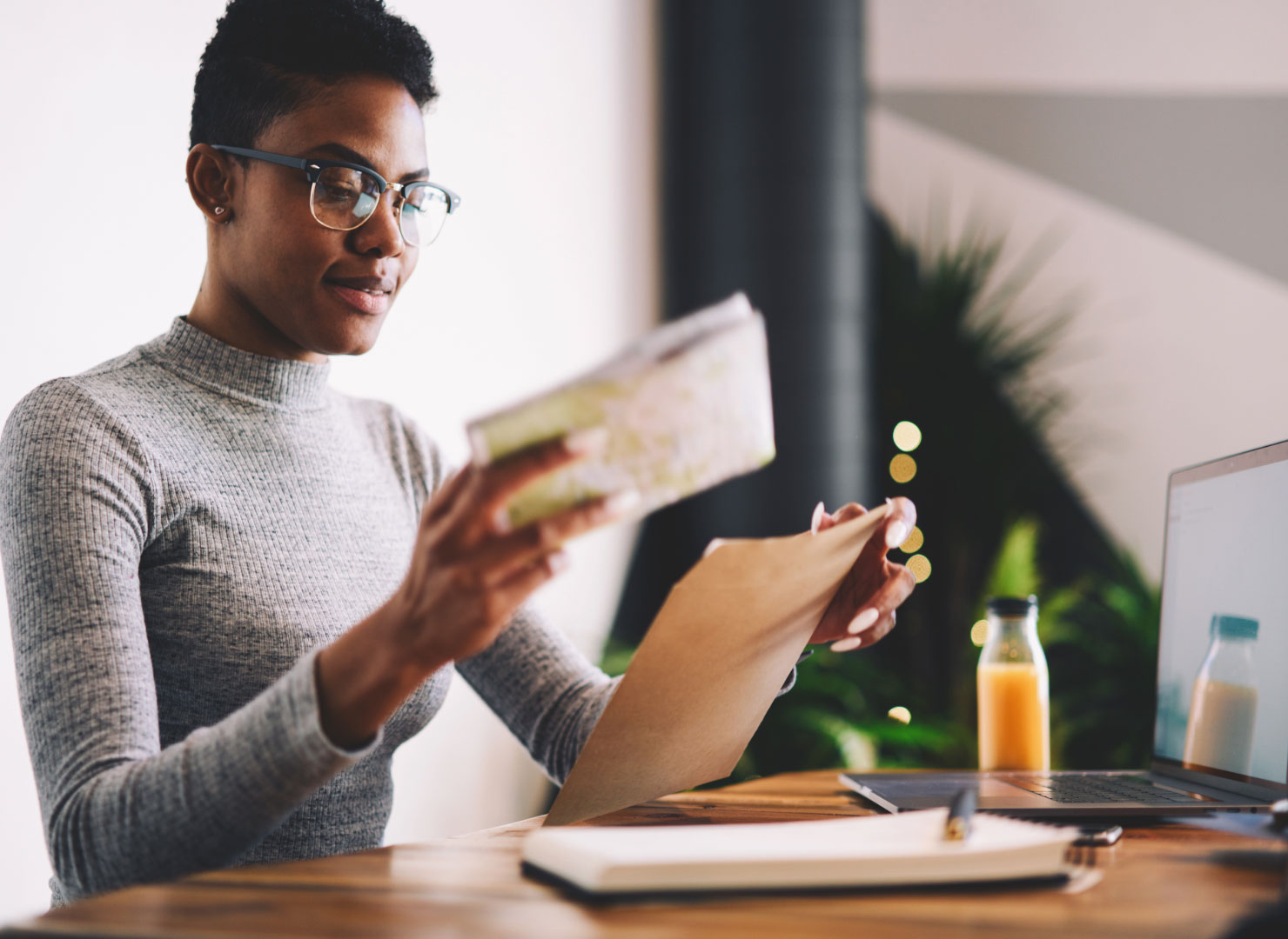A woman opening a personalized direct mail letter from a business.