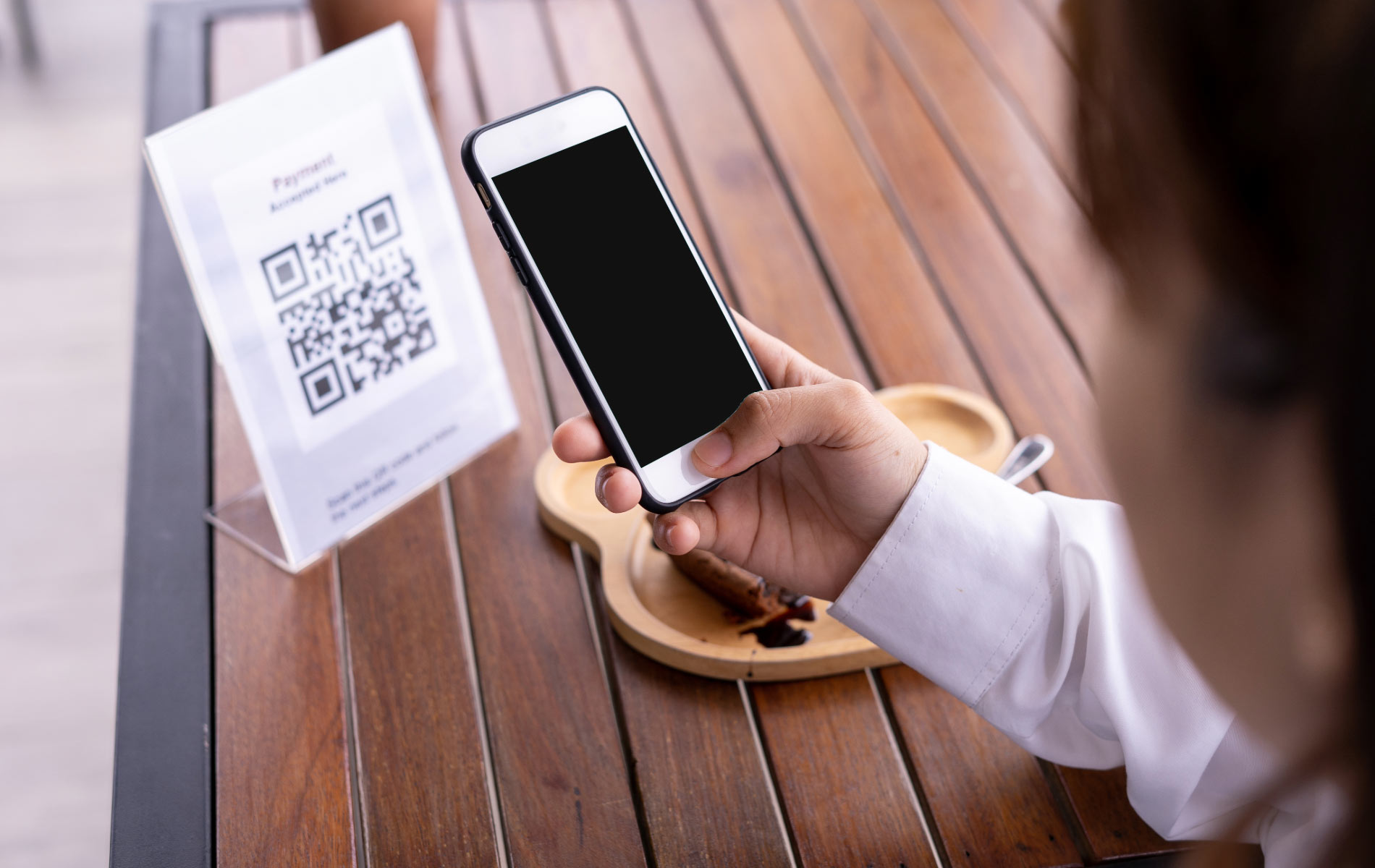 A customer scanning a QR code that Integrates with Digital Strategies