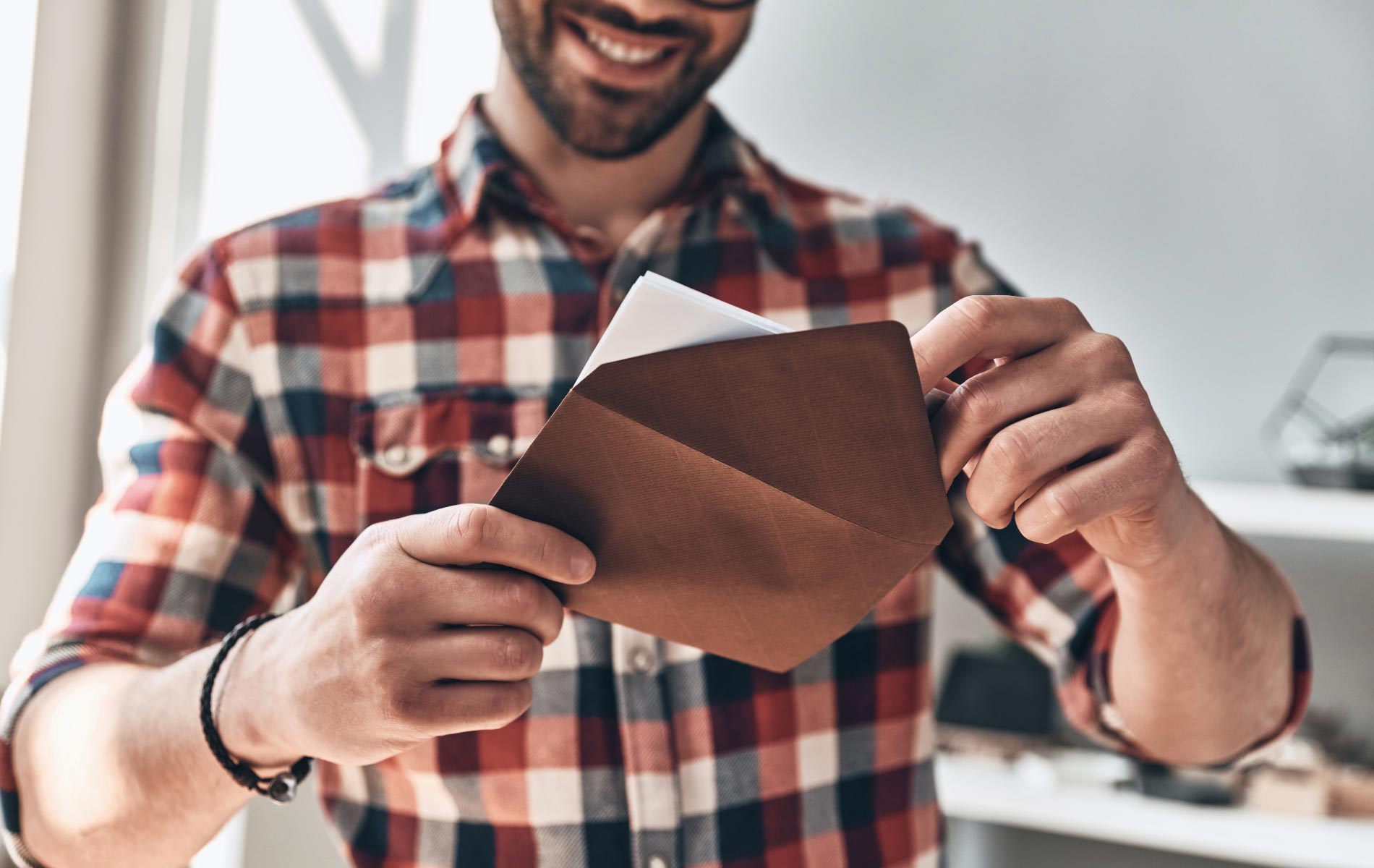 A man receiving a personalized Event Invitation in the mail.