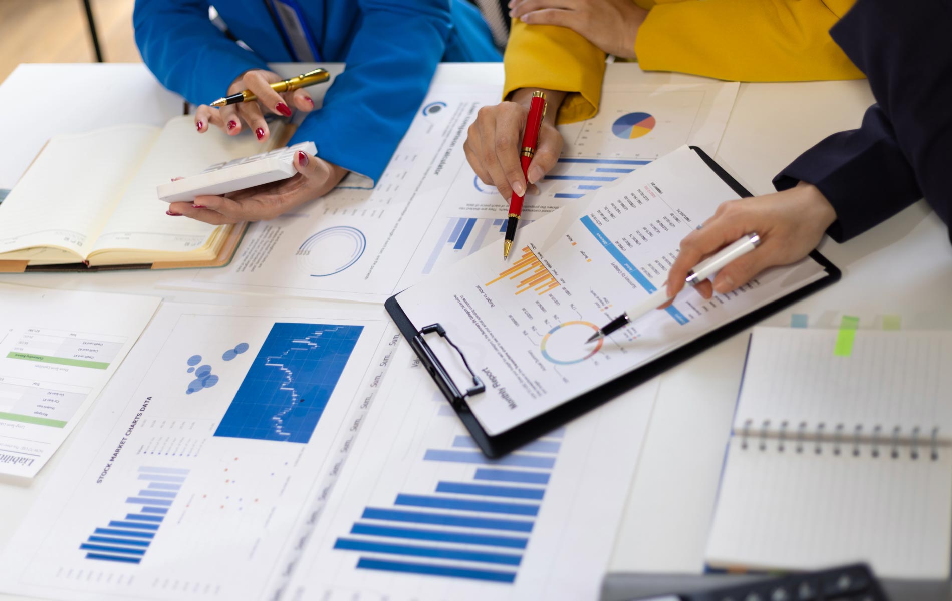 A business team reviewing Annual Reports and Impact Statements.