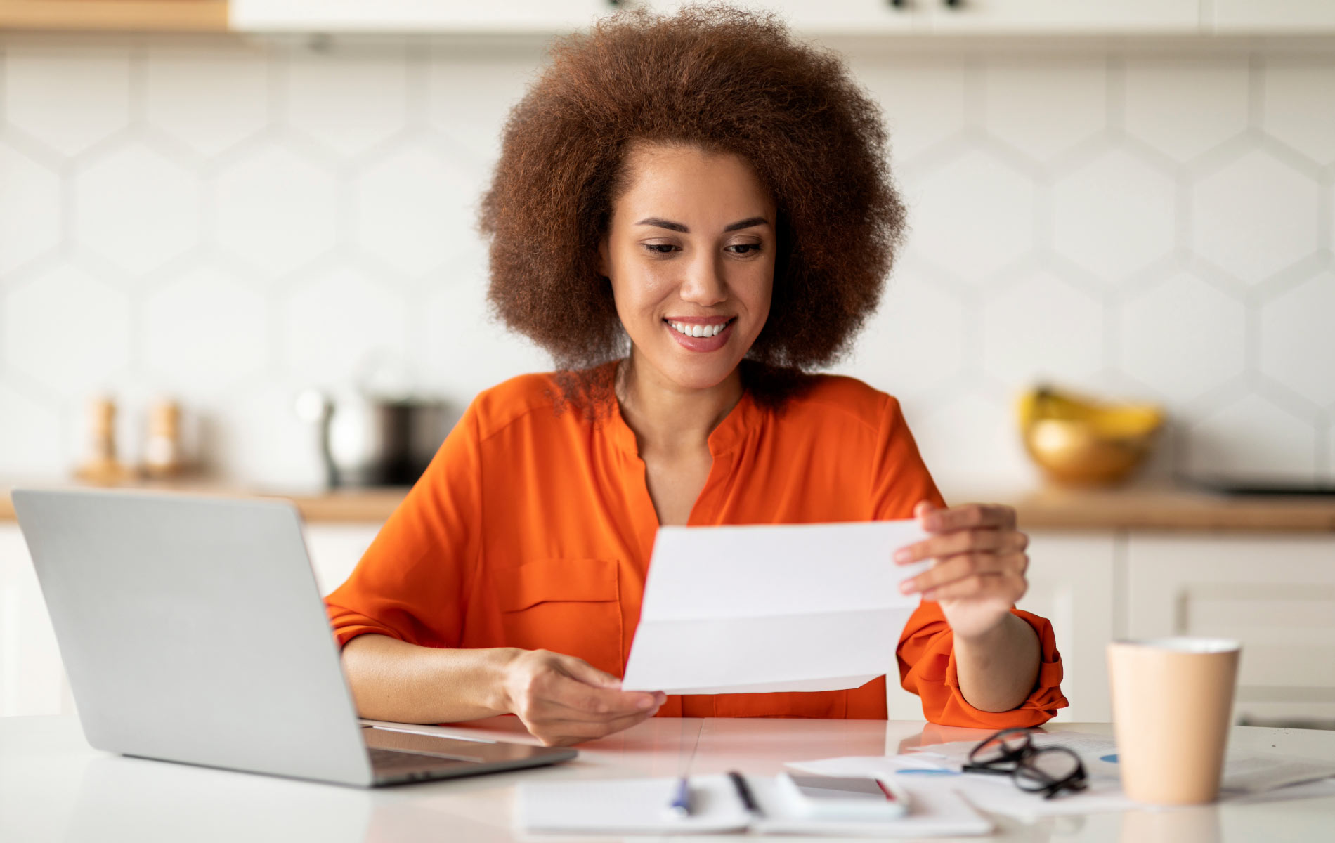A woman reading a personalized letter from a business.